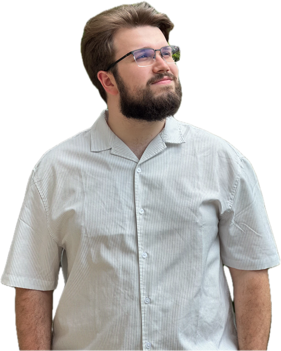 Vuk Aranđelović in a light striped short-sleeved shirt, smiling and looking up to the side